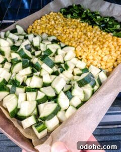 chopped ingredients in a baking sheet against a white background
