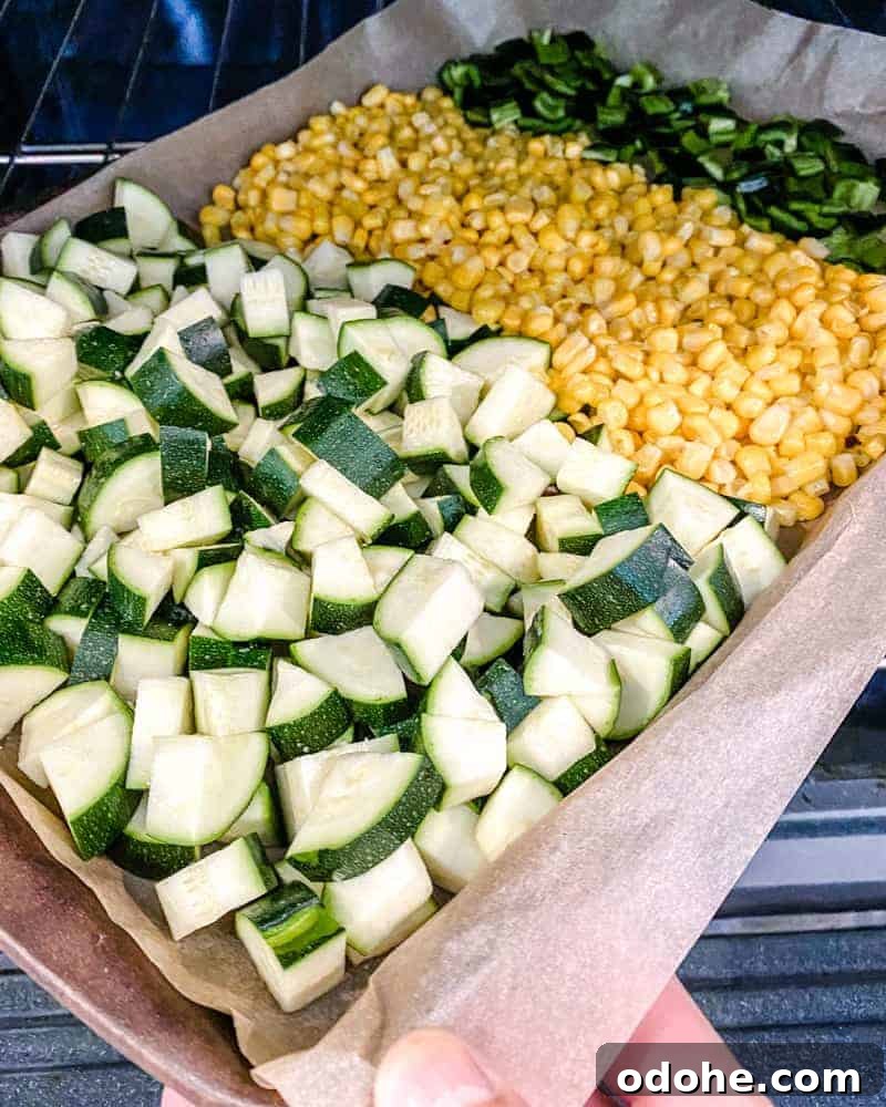 chopped ingredients in a baking sheet against a white background