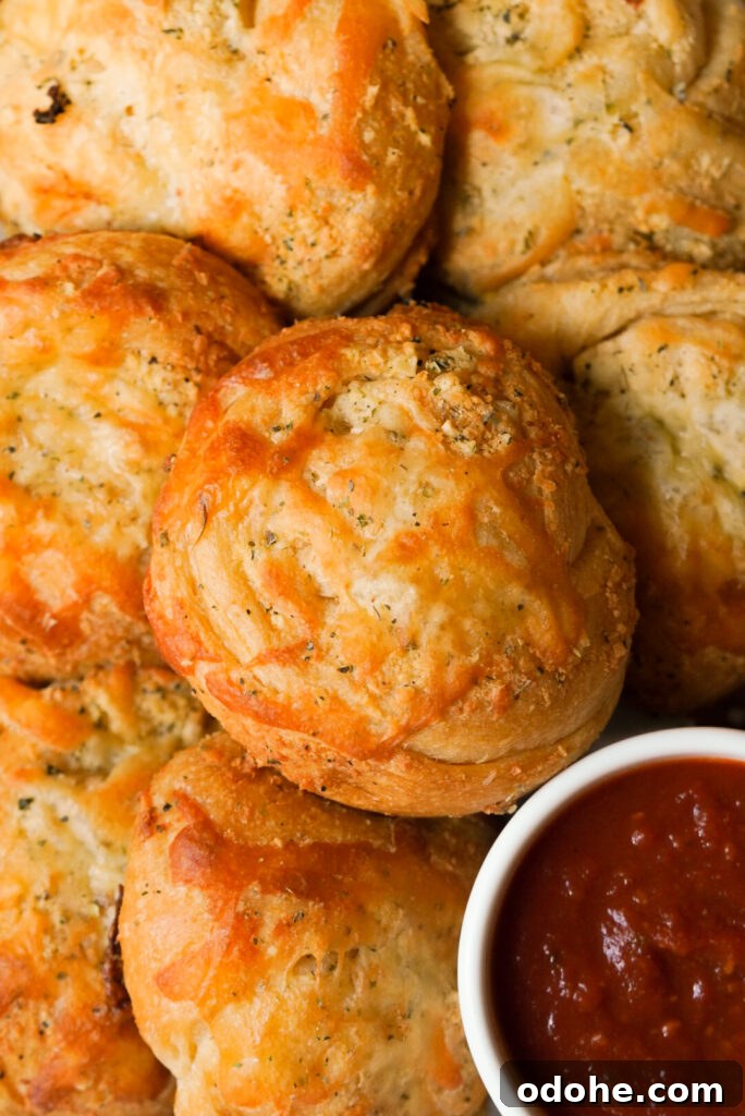 overhead shot of garlic knots and marinara sauce on the side