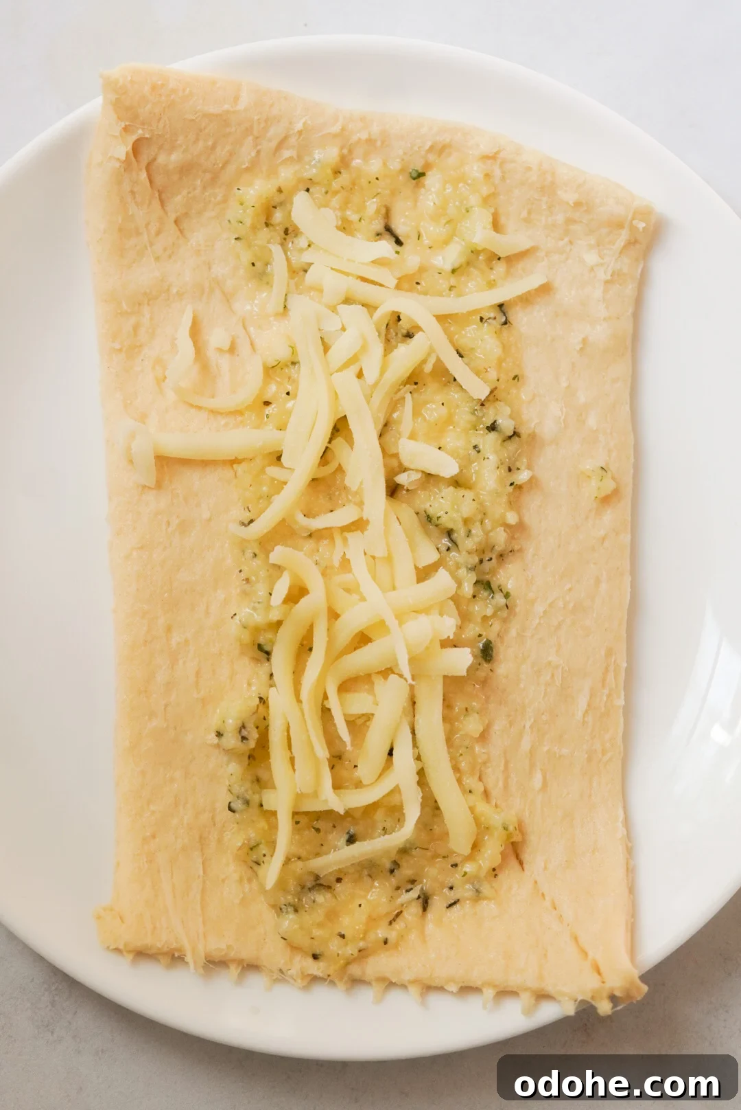 crescent dough sheet topped with garlic butter and cheese