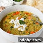Side shot of the soup in a bowl with a spoon.