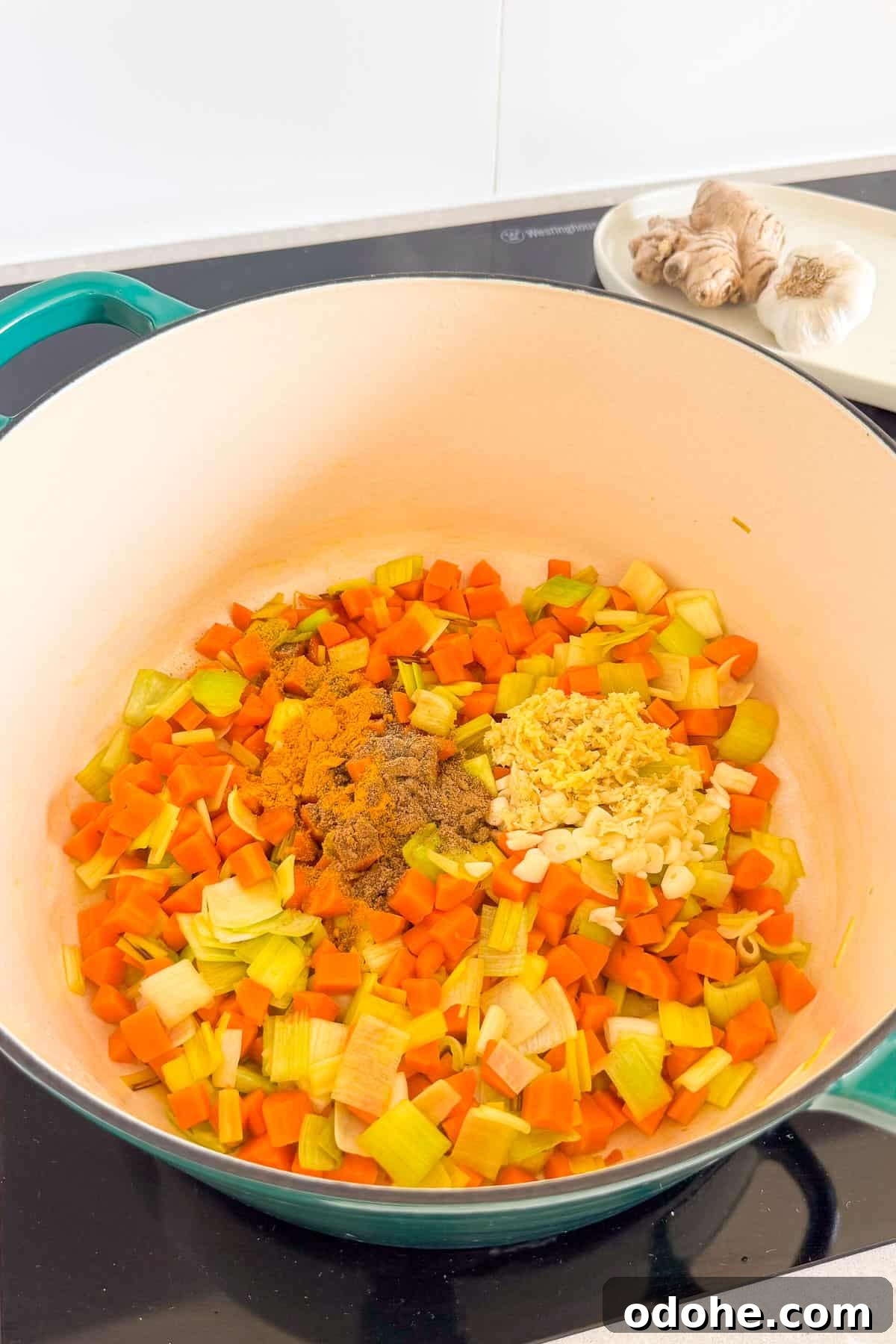 Grated ginger, garlic and spices added to the pot.