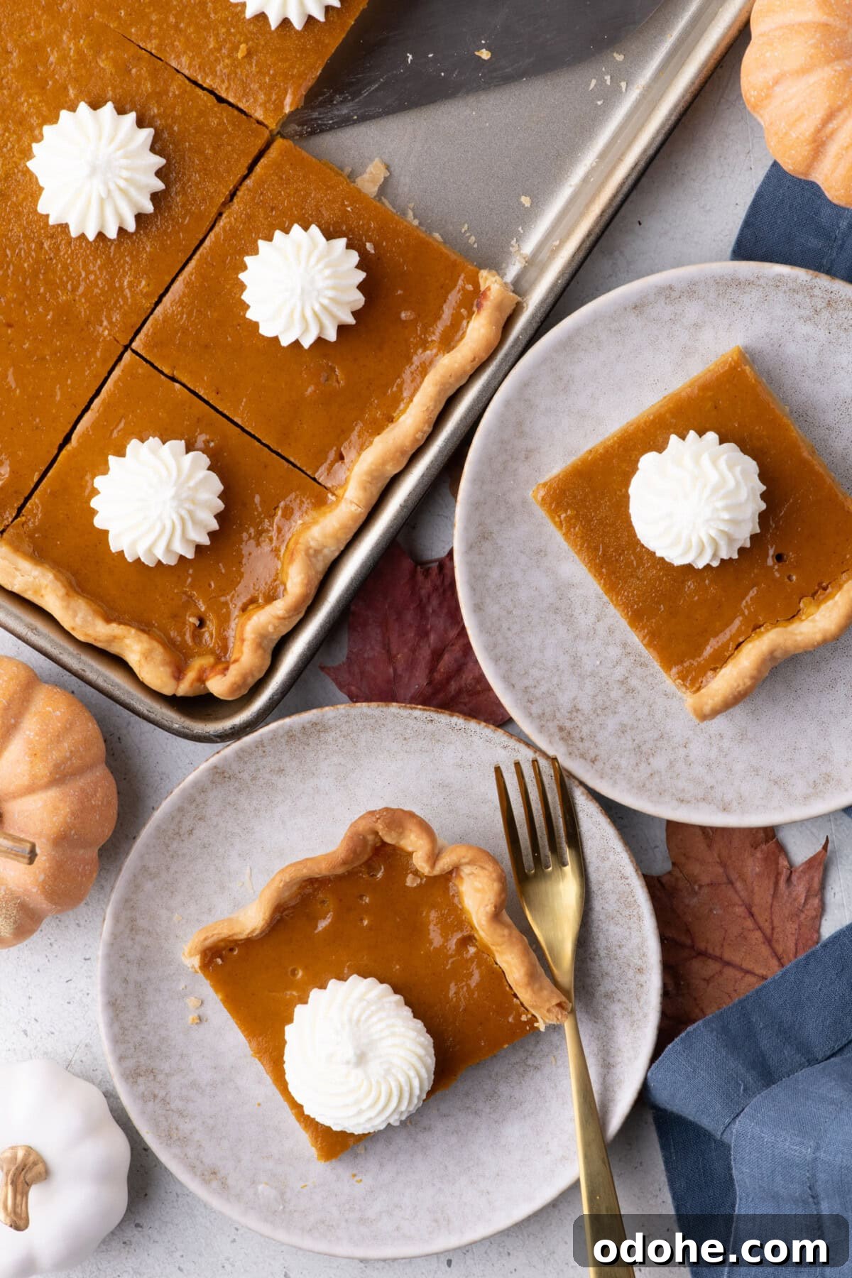 Giant Pumpkin Slab Pie Recipe for Fall Gatherings 2 Two pieces of Pumpkin Slab Pie on plates topped with whipped cream
