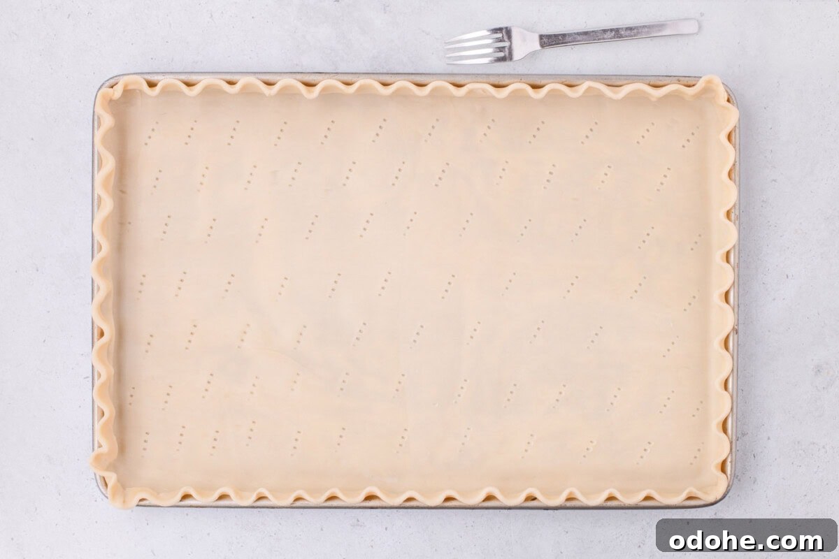 Giant Pumpkin Slab Pie Recipe for Fall Gatherings 10 scalloped pie dough in a jelly roll pan