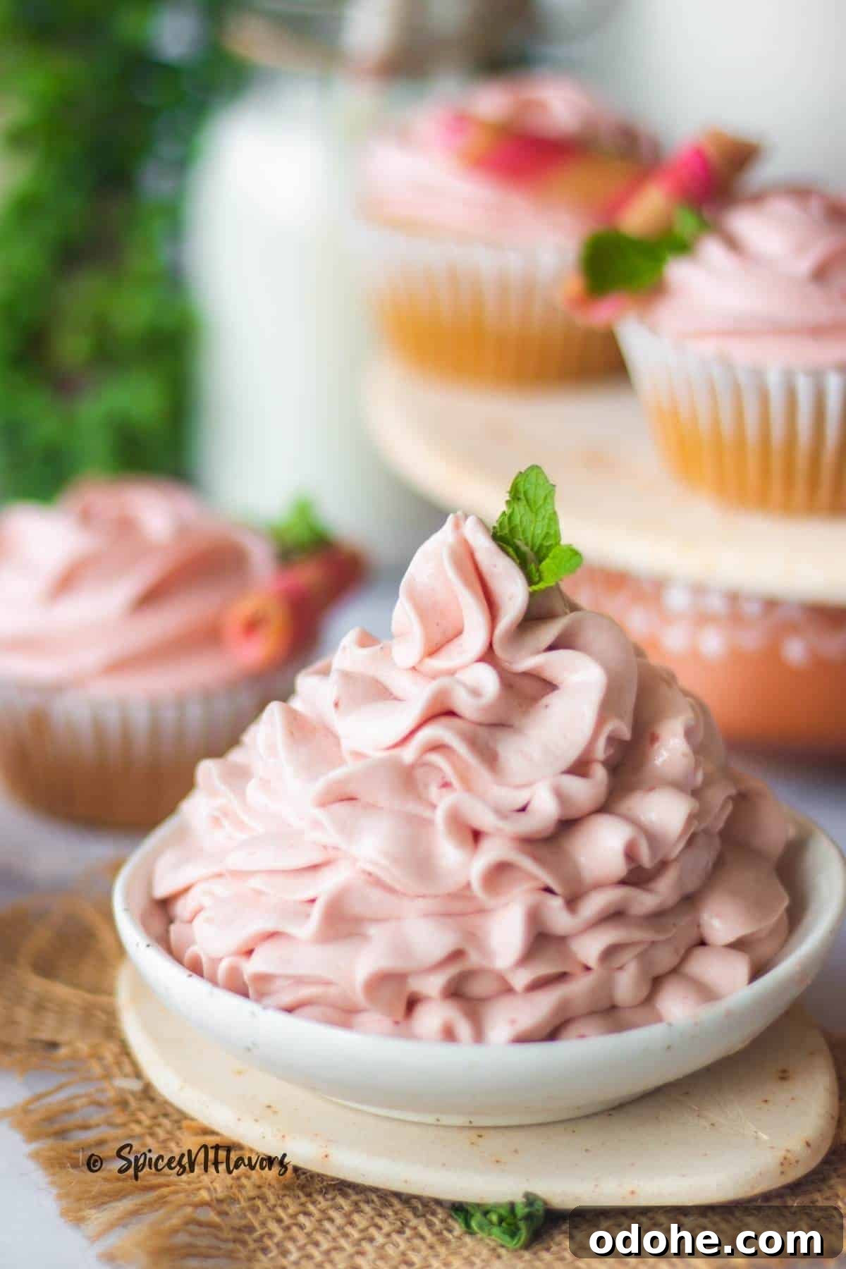Strawberry Cream Cheese Cake Filling Recipe for Moist Layer Cakes 2 strawberry cream cheese filling piped on a white bowl with vanilla cupcakes placed in the background