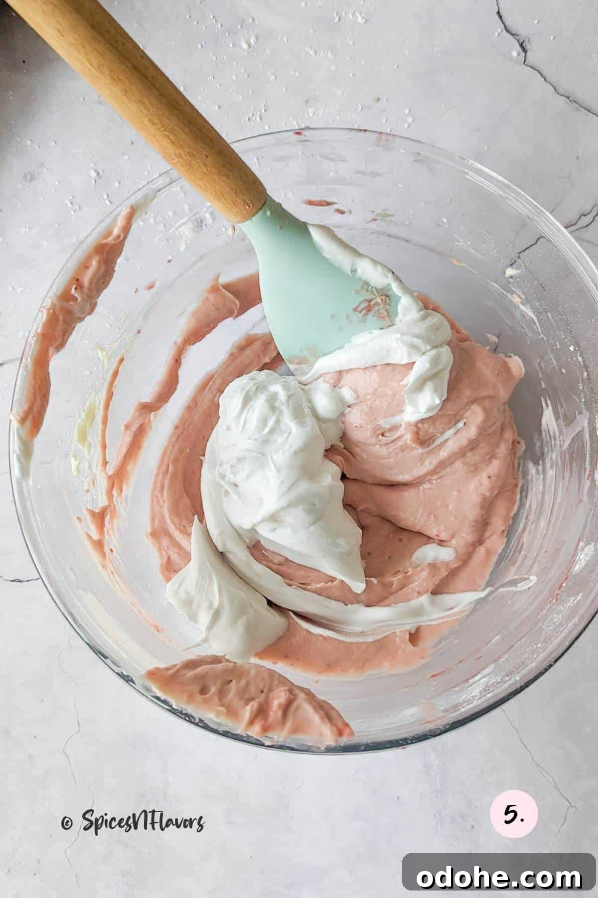 Strawberry Cream Cheese Cake Filling Recipe for Moist Layer Cakes 6 mixing small portion of whipped cream into strawberry cream cheese mixing
