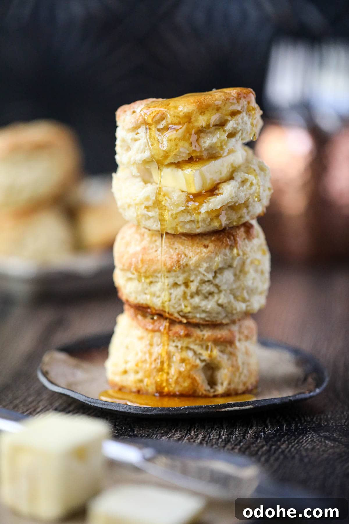 southern buttermilk biscuits stacked on a brown plate.