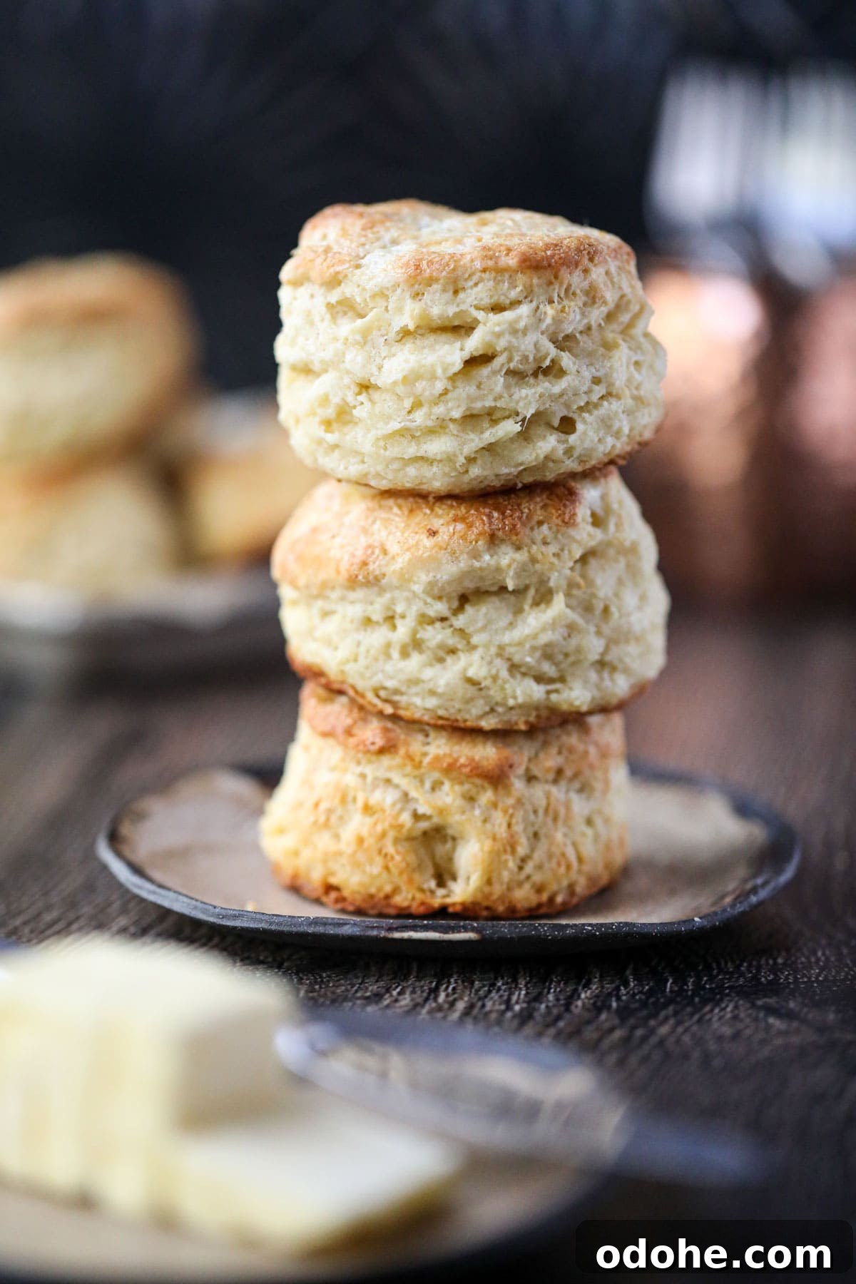 Southern buttermilk biscuits stacked on a brown plate.