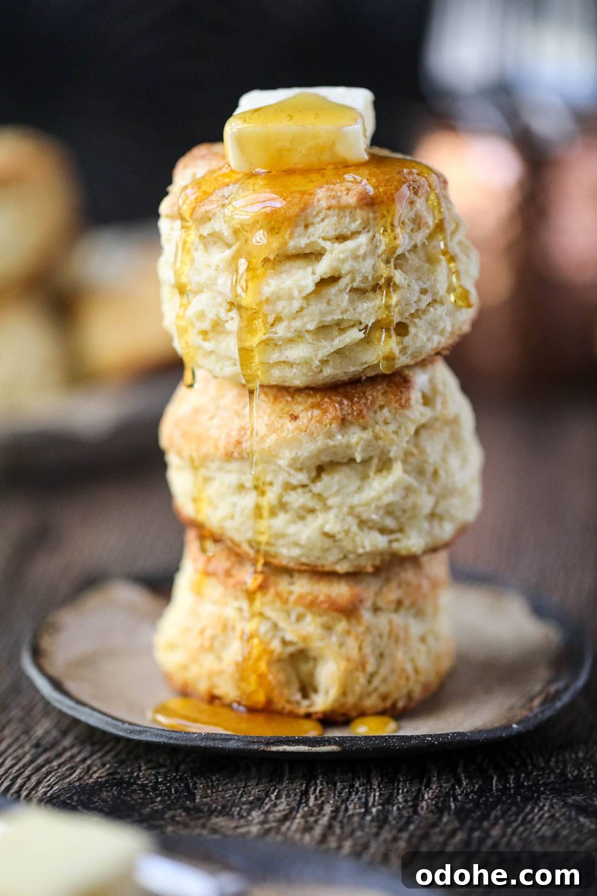 southern buttermilk biscuits stacked on a brown plate.