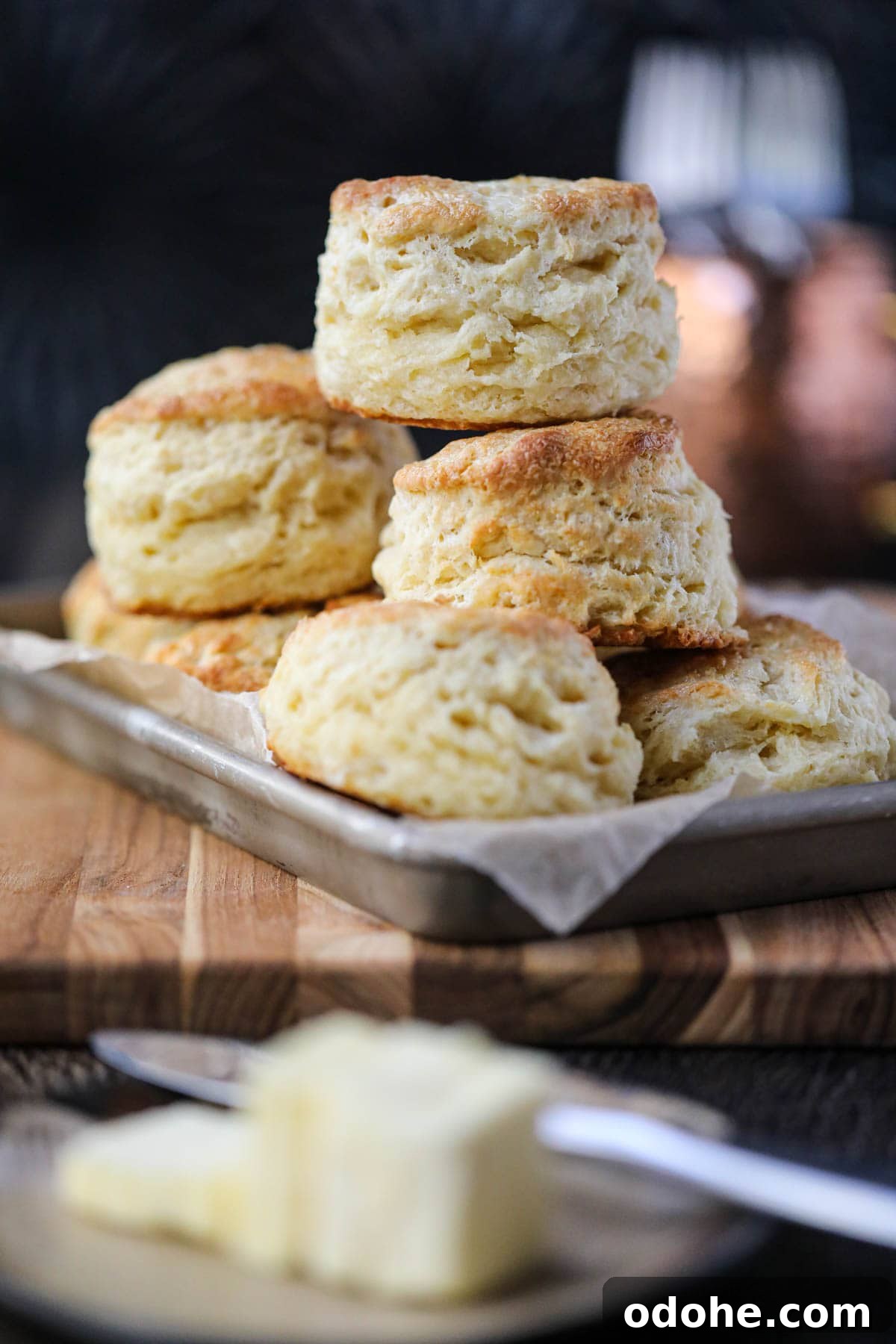 southern buttermilk biscuits stacked on a tray.