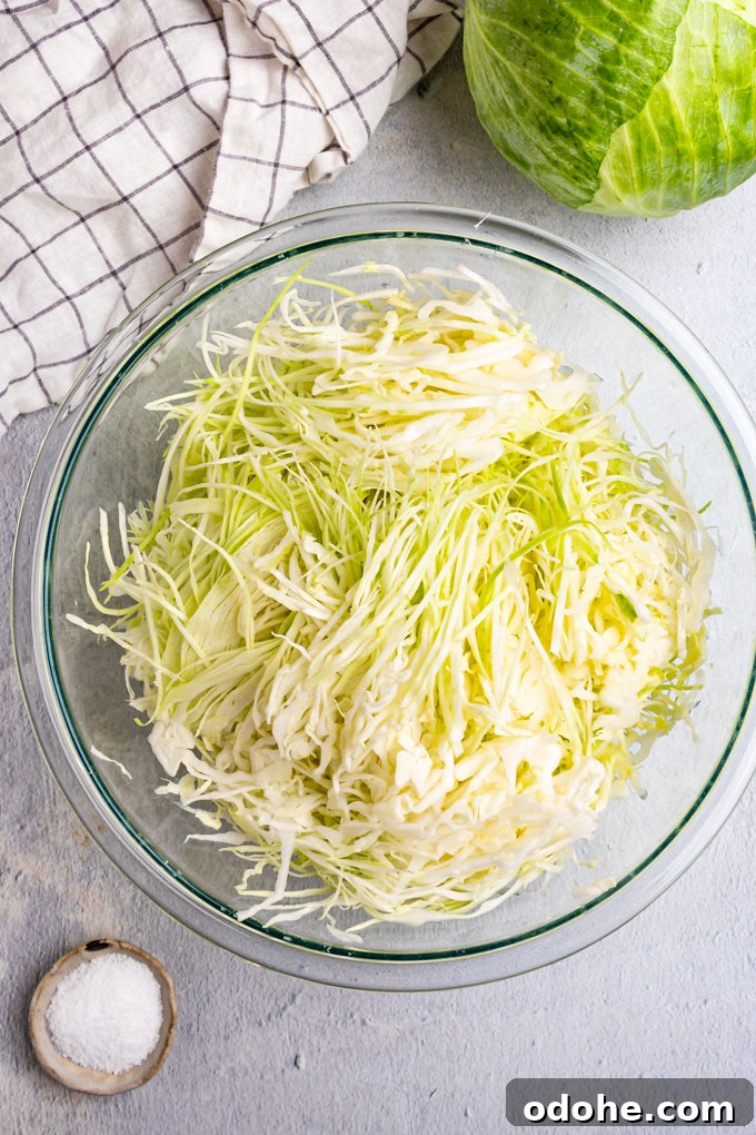 Shredded cabbage in a bowl for how to make sauerkraut.