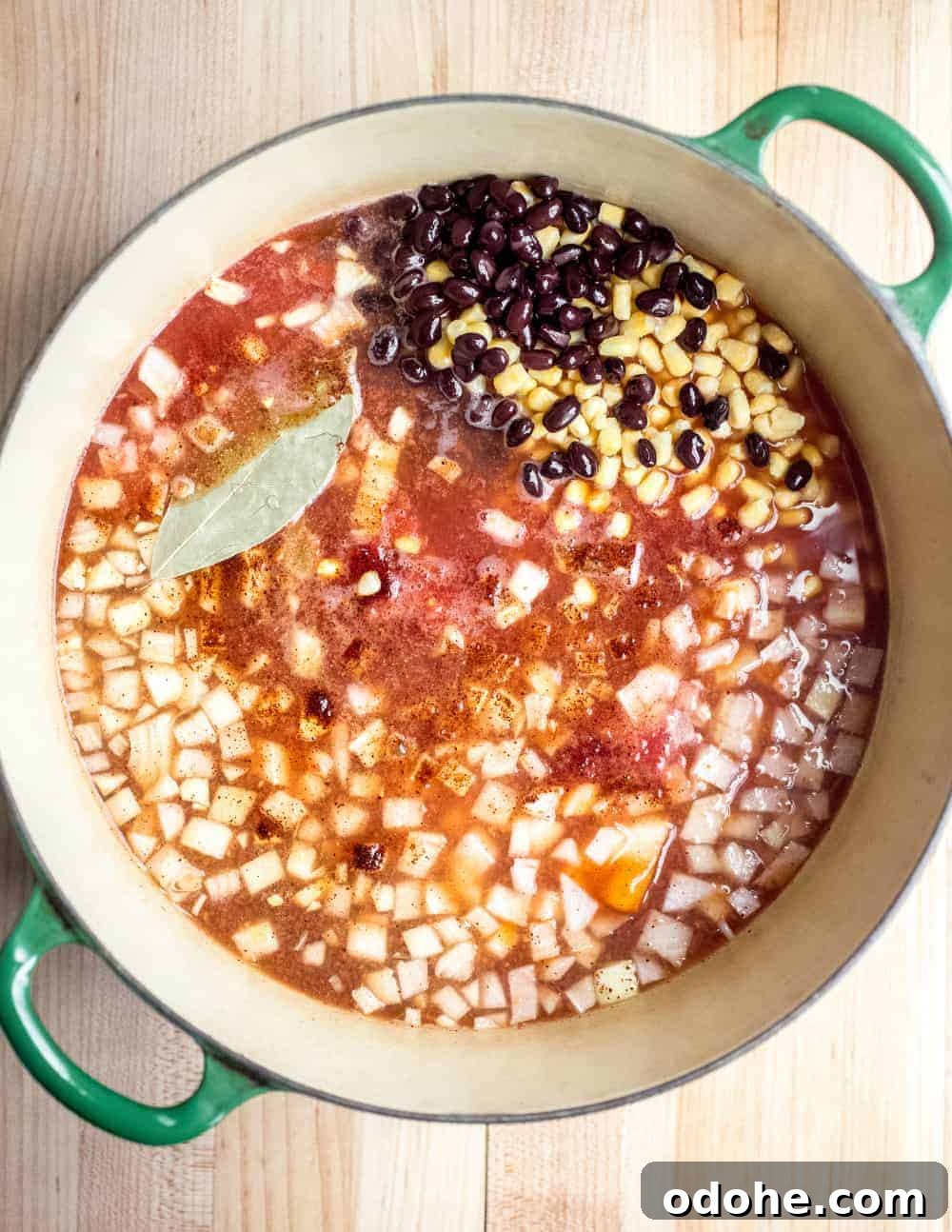 Authentic Mexican Tortilla Soup Recipe with Crispy Tortilla Strips 3 Ingredients for tortilla soup in a Dutch oven, ready to be simmered