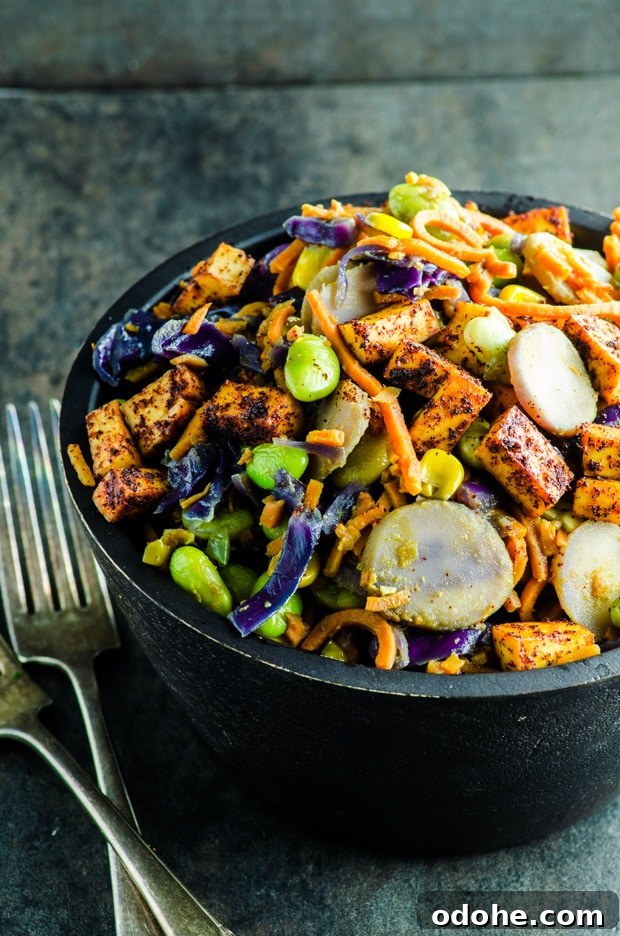 Sweet Potato Noodle Stir-Fry with Creamy Peanut Sauce 3 A colorful bowl of spiralized sweet potato noodles with cabbage, edamame, corn, water chestnuts and tofu in peanut sauce.