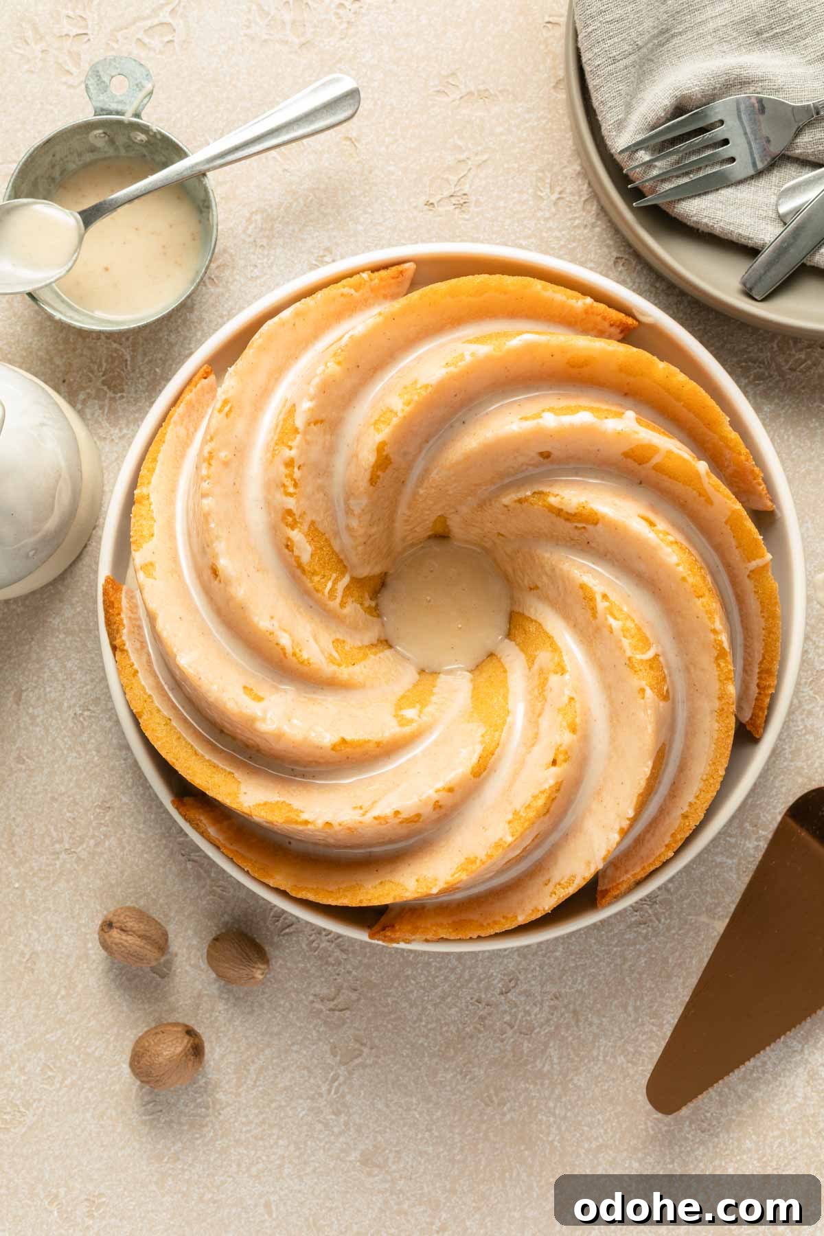 Decadent Eggnog Bundt Cake Recipe for Holiday Gatherings 2 Overhead view of eggnog cake on a plate and topped with eggnog glaze.