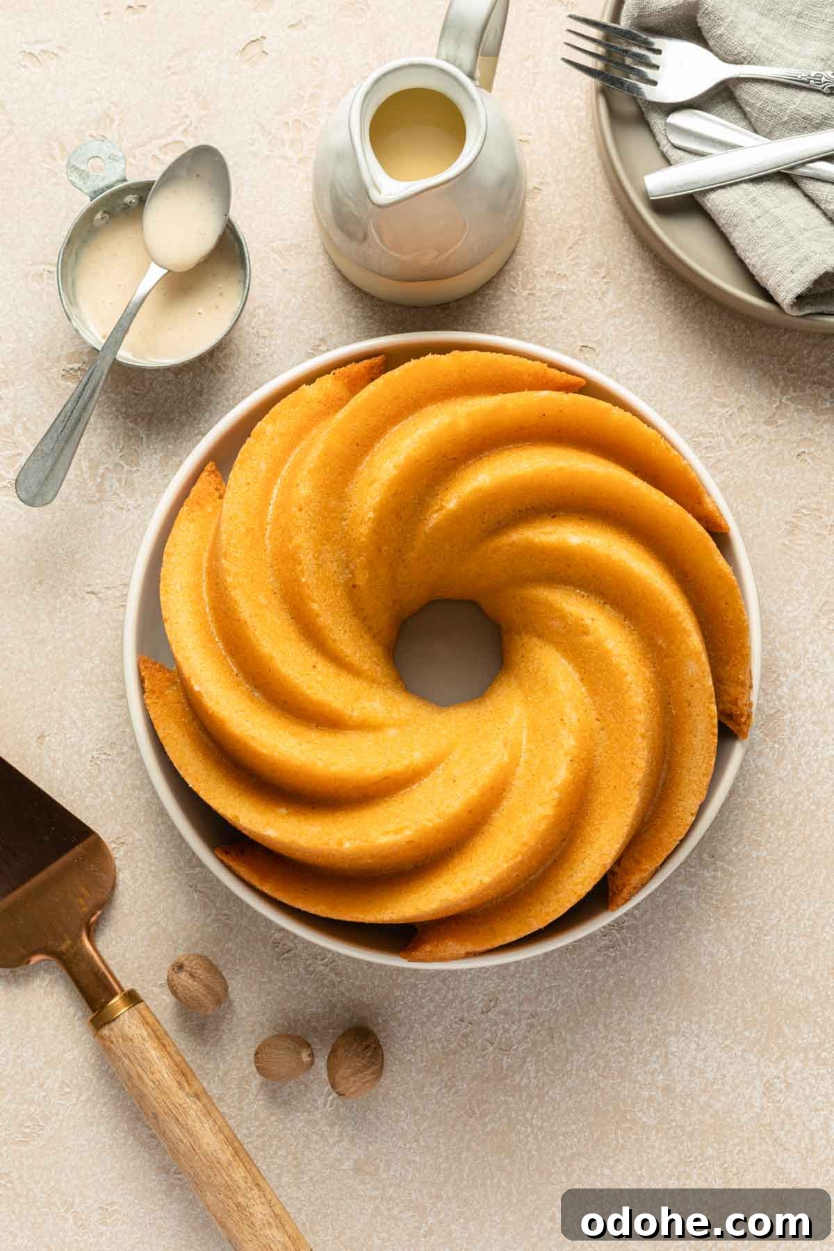 Decadent Eggnog Bundt Cake Recipe for Holiday Gatherings 5 Unglazed bundt cake on a round plate.