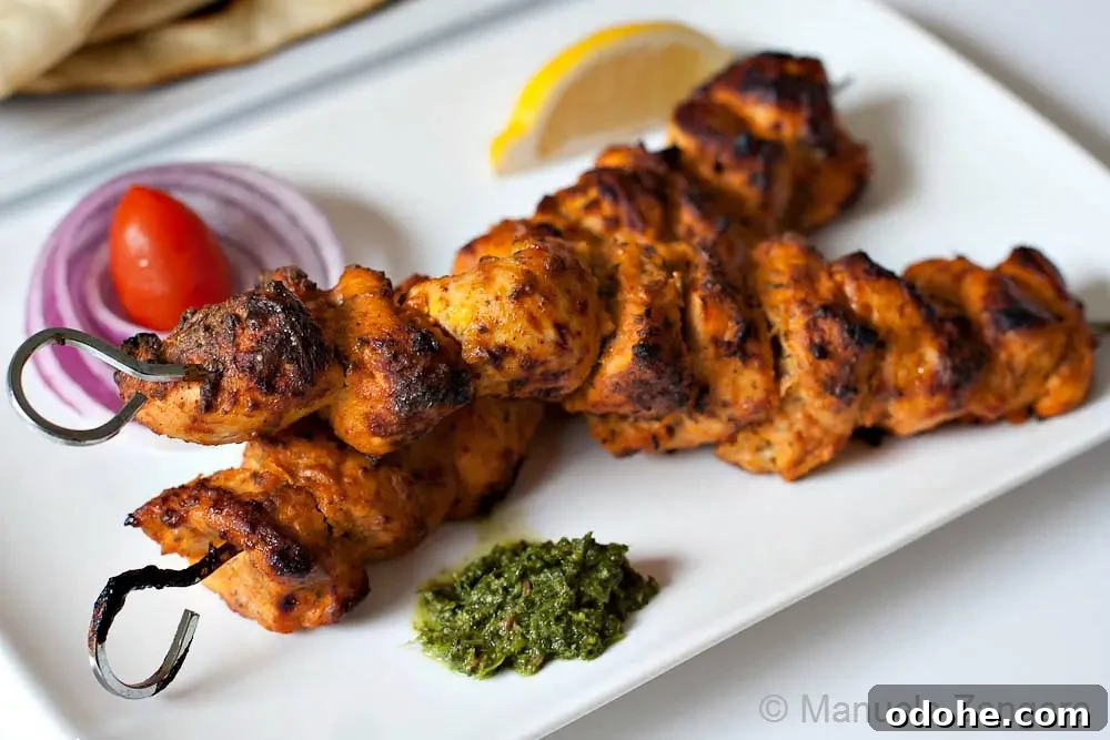 Chicken Tikka Recipe: Authentic Murgh Tikka Marinade & Grill Tips 6 Cooked chicken tikka skewers served with chutney, lemon, and onions.