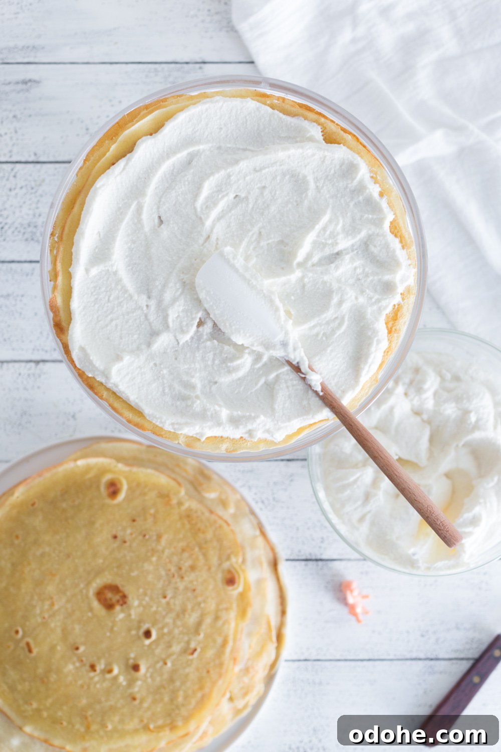 Crepe King Cake: Traditional French King Cake Made with Crepes 12 Crepe King Cake adding whipped mascarpone