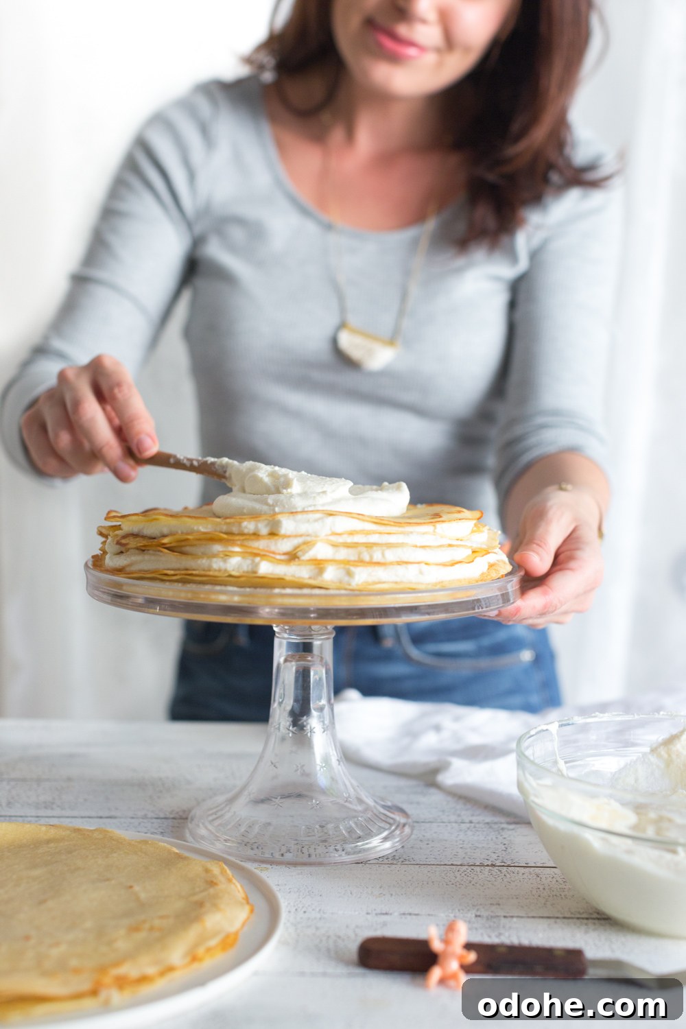 Crepe King Cake: Traditional French King Cake Made with Crepes 13 Crepe King Cake adding whipped mascarpone