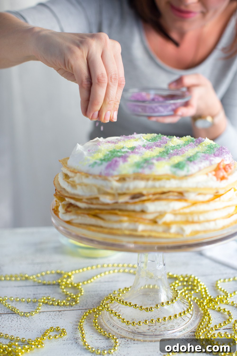 Crepe King Cake: Traditional French King Cake Made with Crepes 18 Crepe King Cake - adding sprinkles