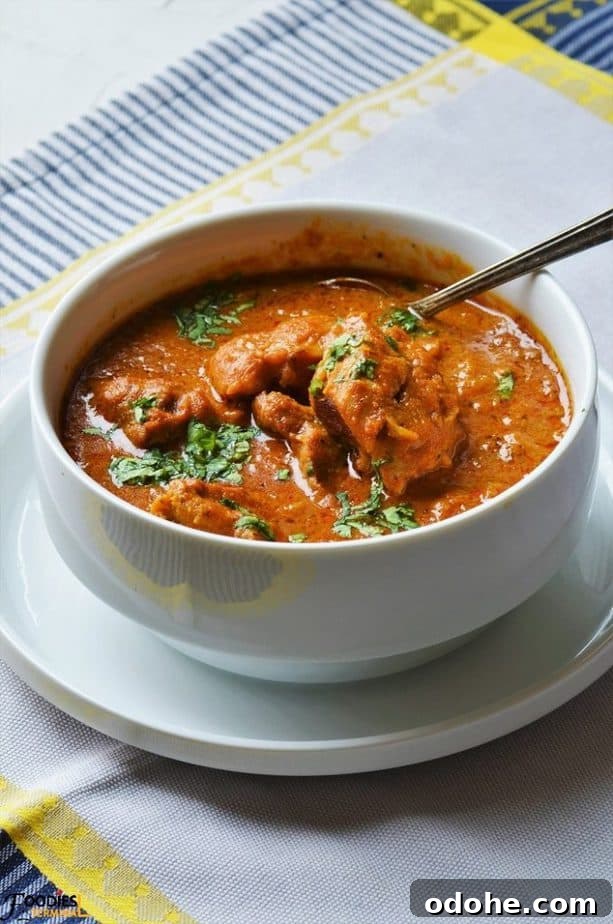 Boneless chicken gravy garnished with cilantro in a bowl