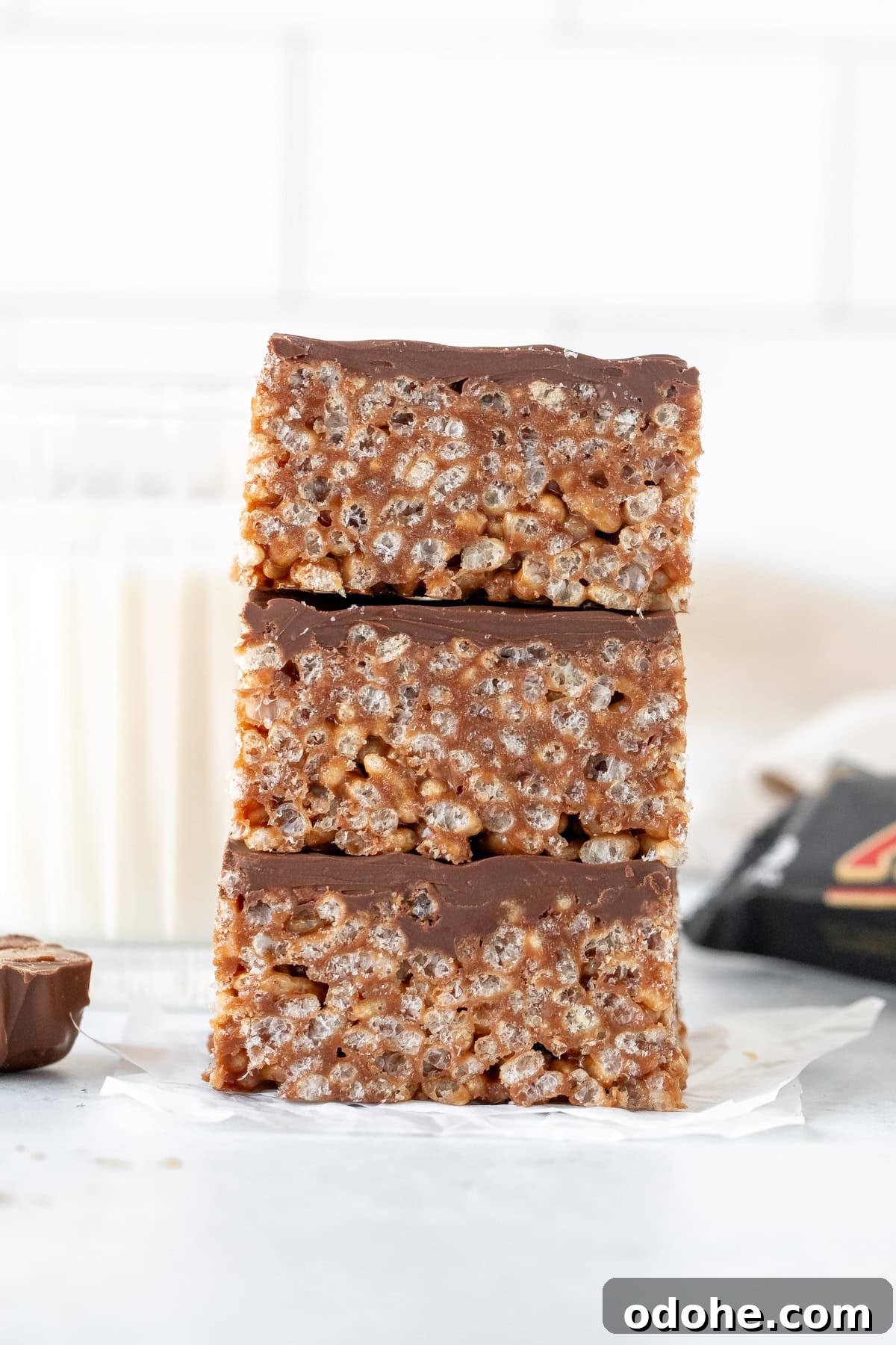Stack of three Mars bar squares with glass of milk