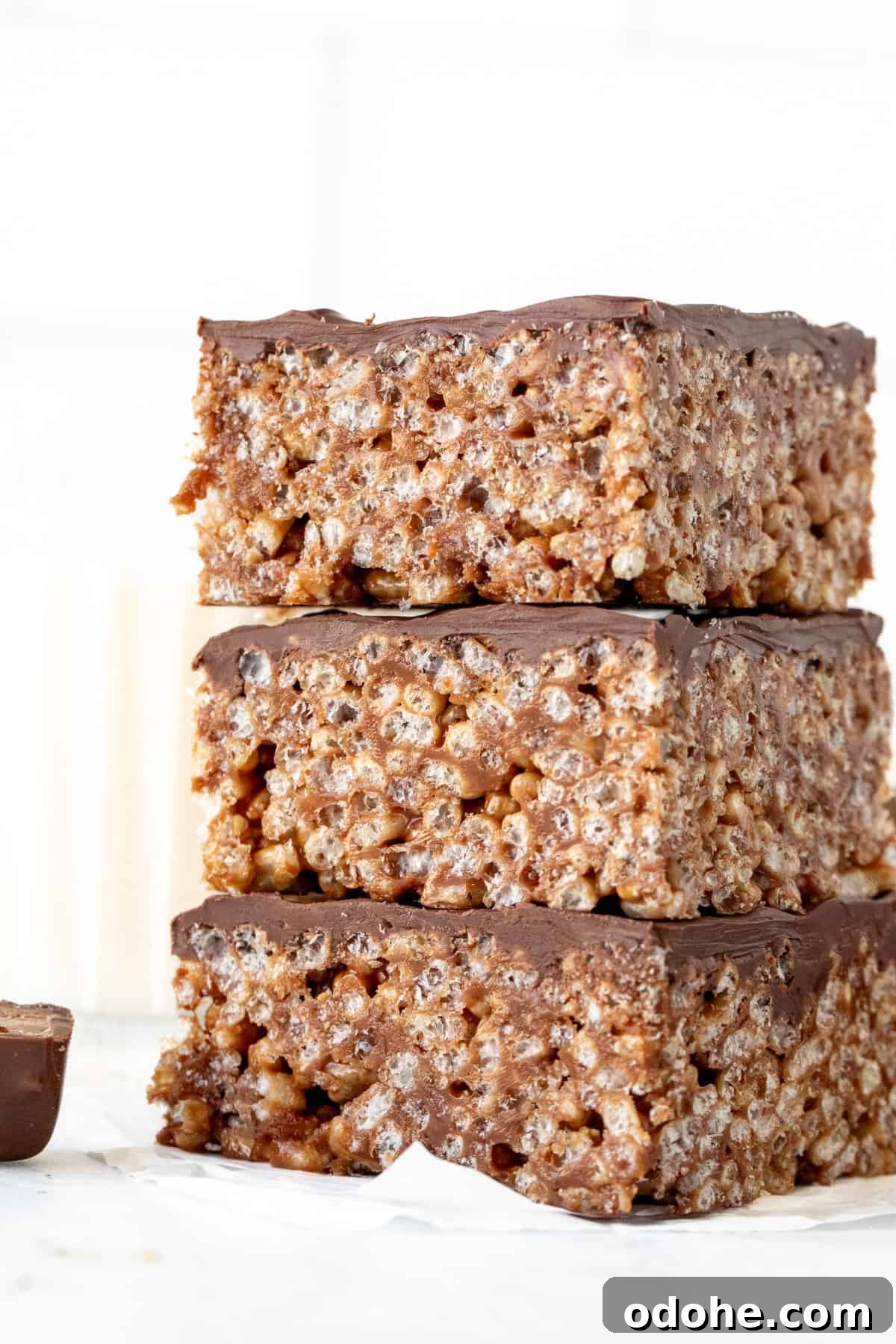 Mars bar squares with chocolate topping, stacked on top of each other