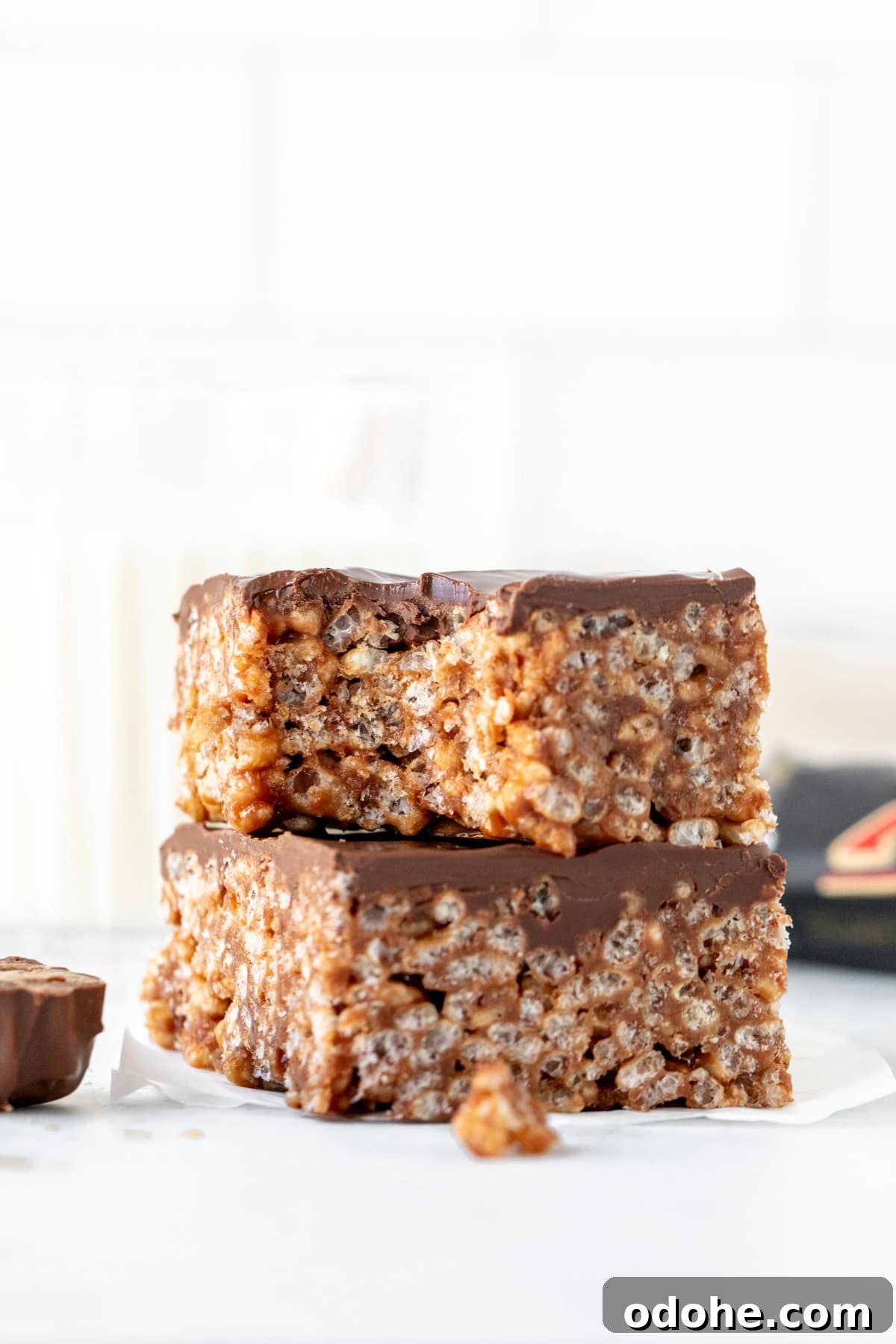 Two Mars Bars squares, stacked on top of each other. Top square has a bite taken out