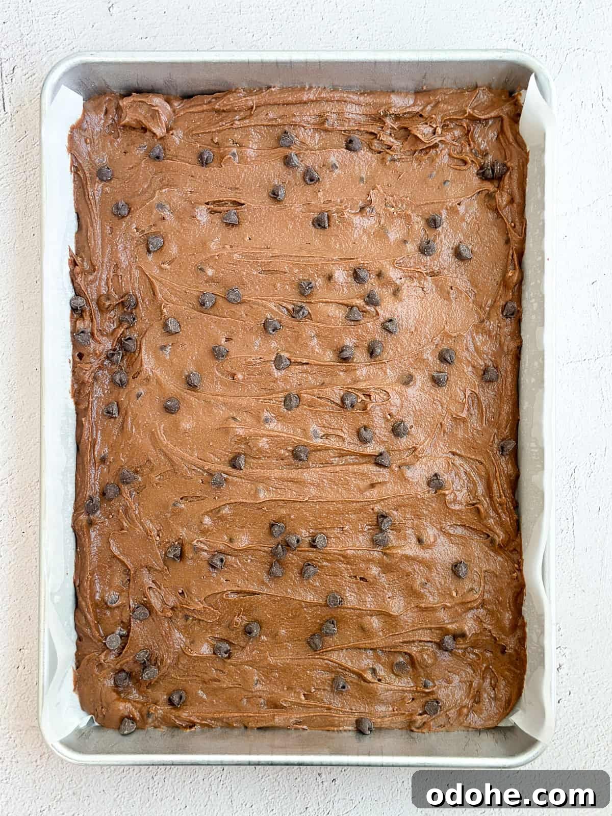 Chewy Sheet Pan Brownies: Perfect Brownie Recipe for Sharing 8 brownie batter in the pan before baking.