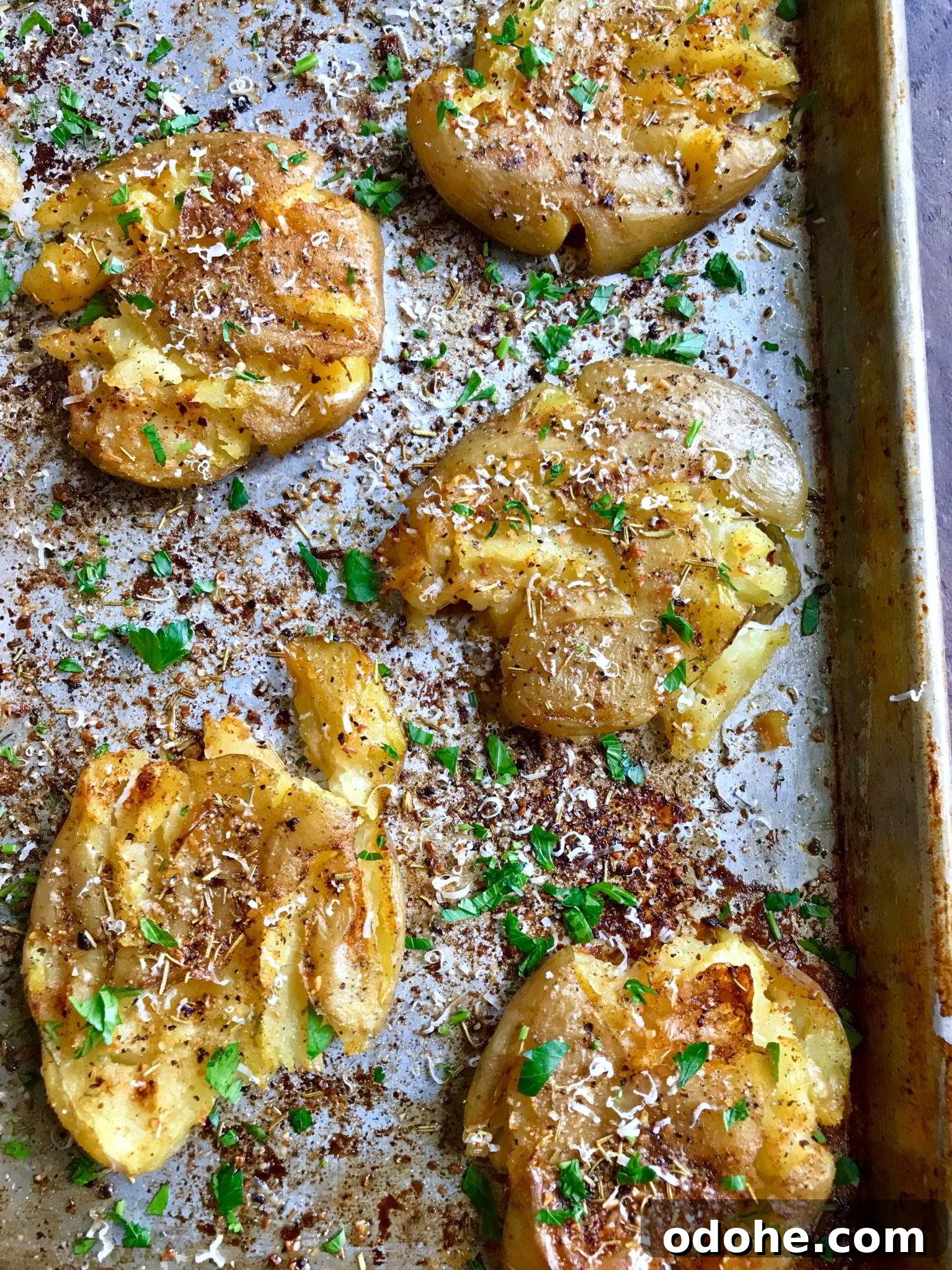 Crispy Parmesan and Herb Roasted Potatoes 2 Parmesan Herbed Potatoes on a baking tray