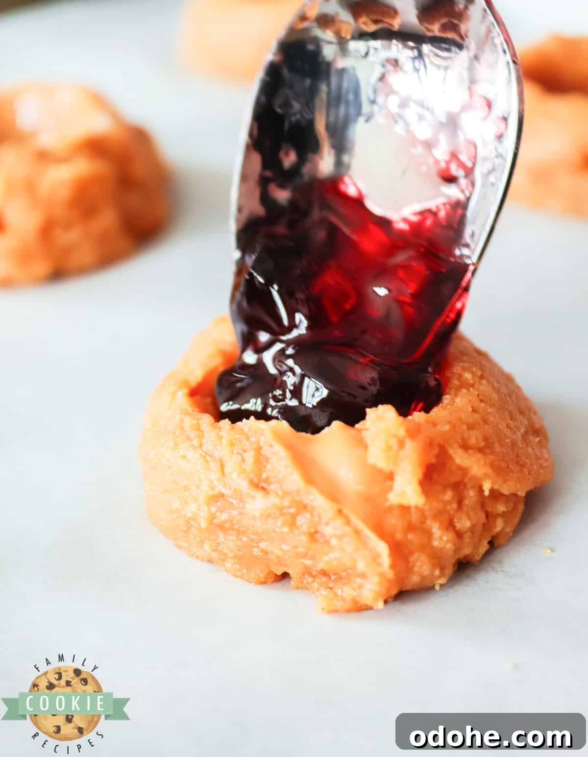 Peanut Butter & Jelly Cookie Recipe — Classic Sandwich Twist 8 Adding jelly to peanut butter cookie.