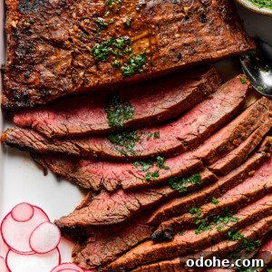Grilled Carne Asada Recipe for Tender, Flavorful Steak 4 Thinly sliced grilled carne asada on a serving platter.