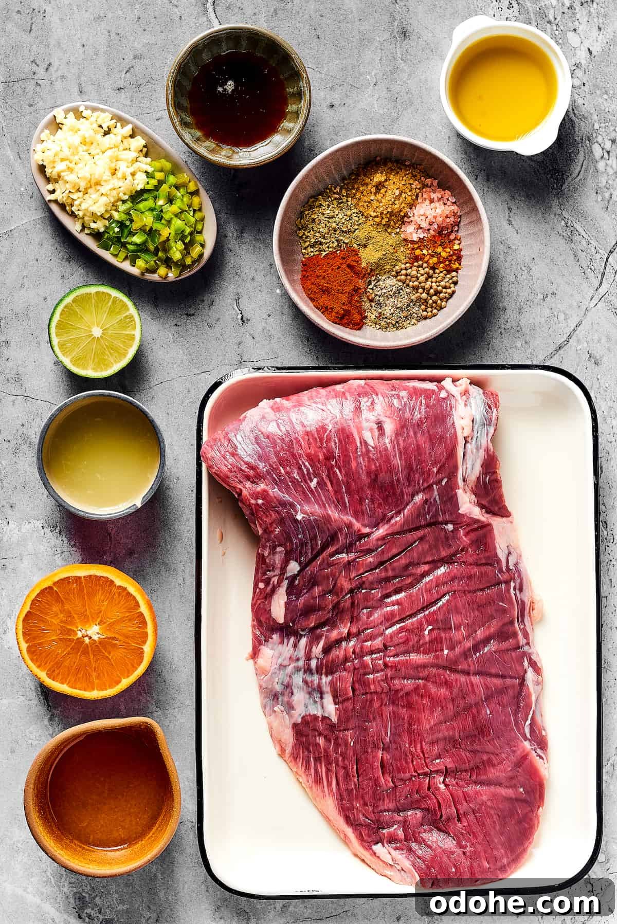 Orange and lime juice, garlic and jalapeno, maple and cumin - this easy Grilled Carne Asada is drenched in a medley of mouthwatering flavors! From top left: Minced garlic and jalapeno, maple syrup, spices, olive oil, lime juice, orange juice, flank steak.