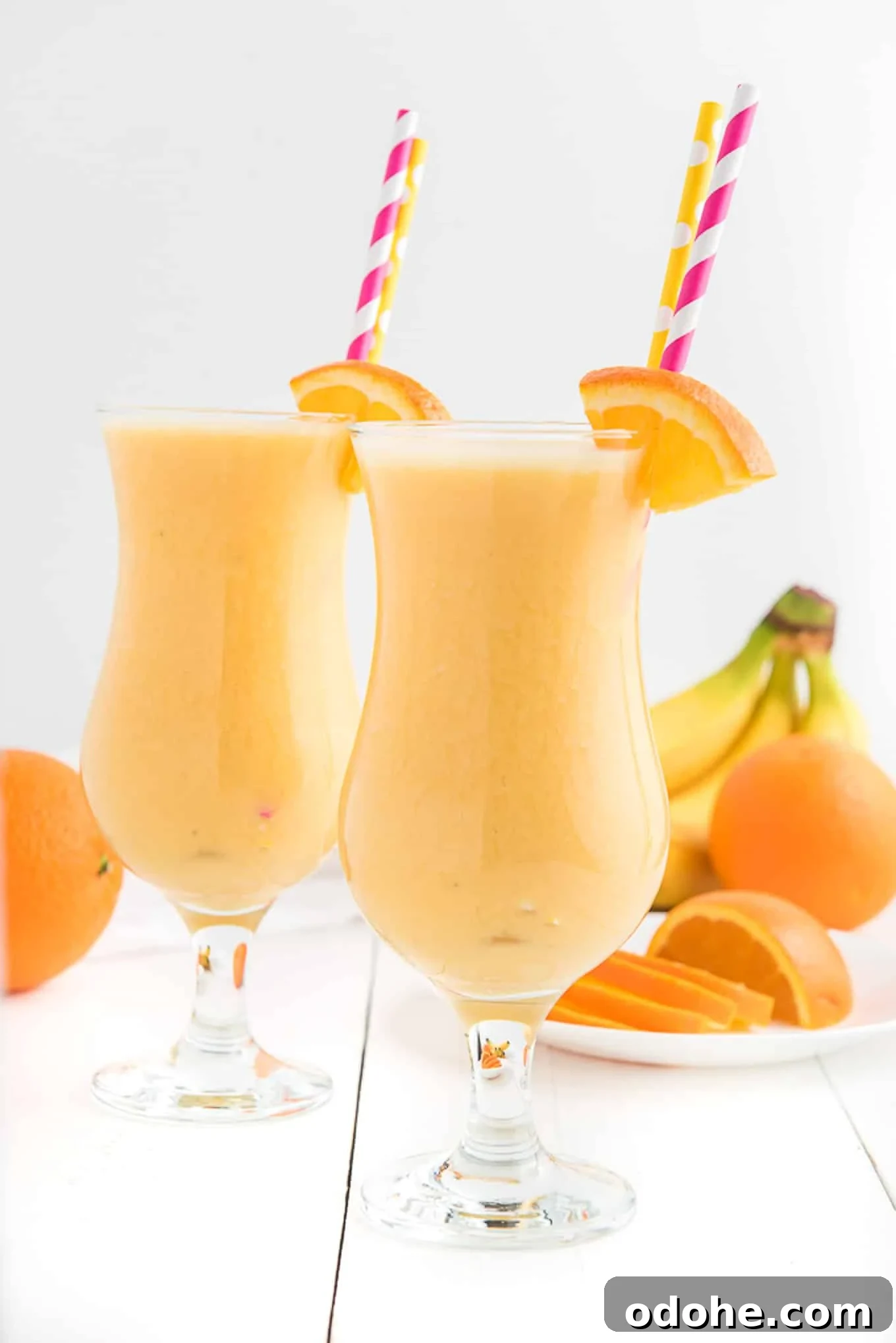 Energizing Orange Smoothie Recipe for Vitamin C Boost 6 Two glasses of orange smoothie side by side.