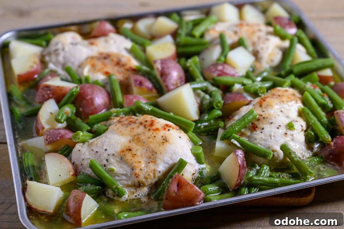 Italian Sheet-Pan Dinner: Simple One-Pan Tray Bake Recipe 7 Italian Chicken Green Beans and Potatoes tray bake on a sheet pan filled with boneless chicken, red potatoes and green beans.