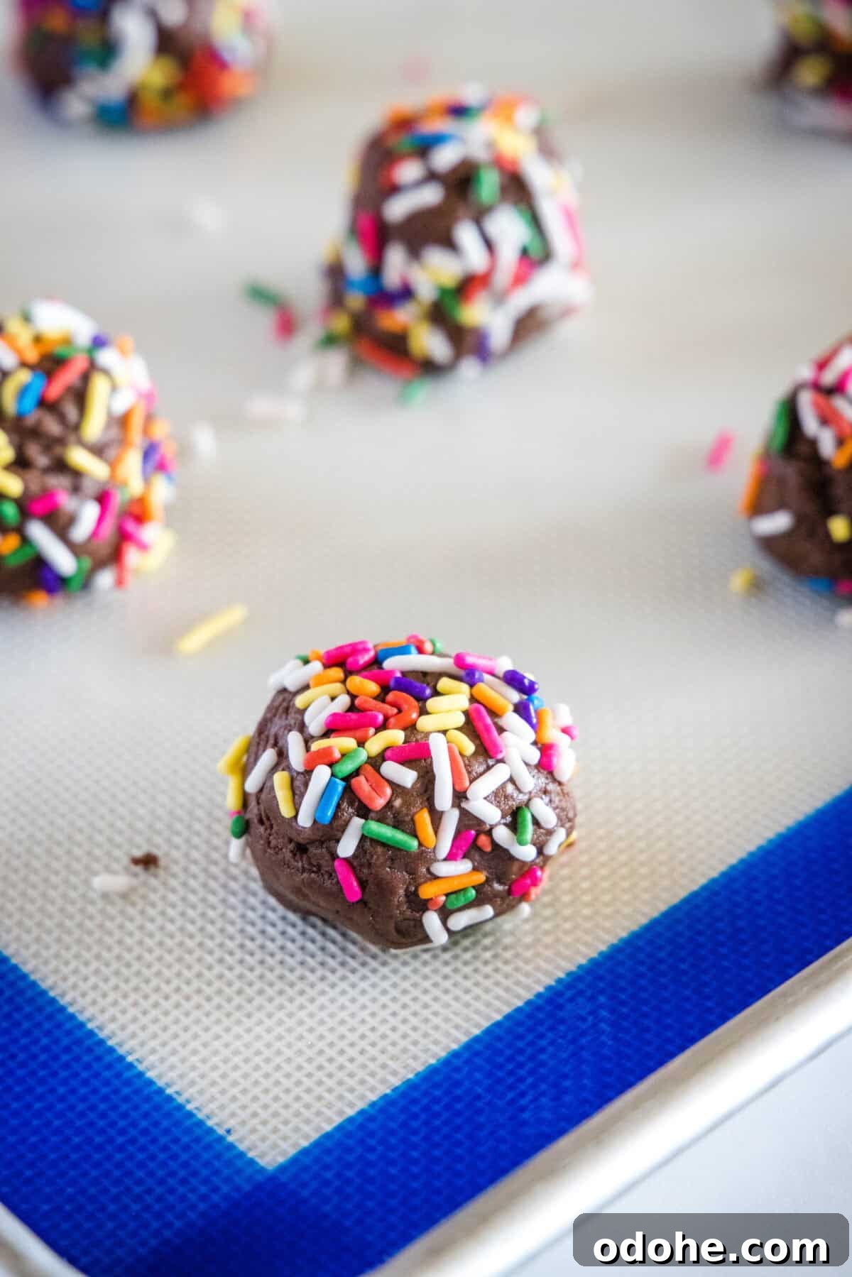 Chocolate Sprinkle Cookies Recipe: Soft Baked Sugar Cookie Treats 6 balls of chocolate sprinkle cookies on baking tray