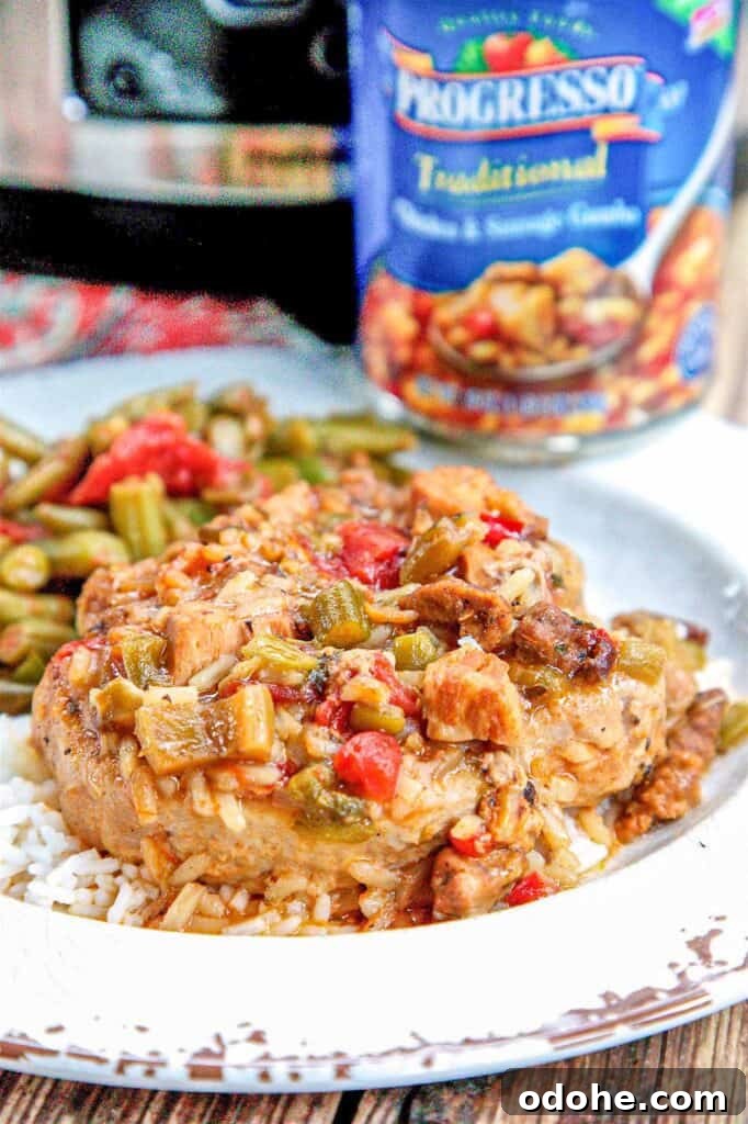 Slow-Cooker Smothered Pork Chops with Onion Gravy 3 smothered pork chops on a plate with green beans