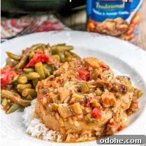Slow-Cooker Smothered Pork Chops with Onion Gravy 4 smothered pork chops on a plate with green beans with text overlay