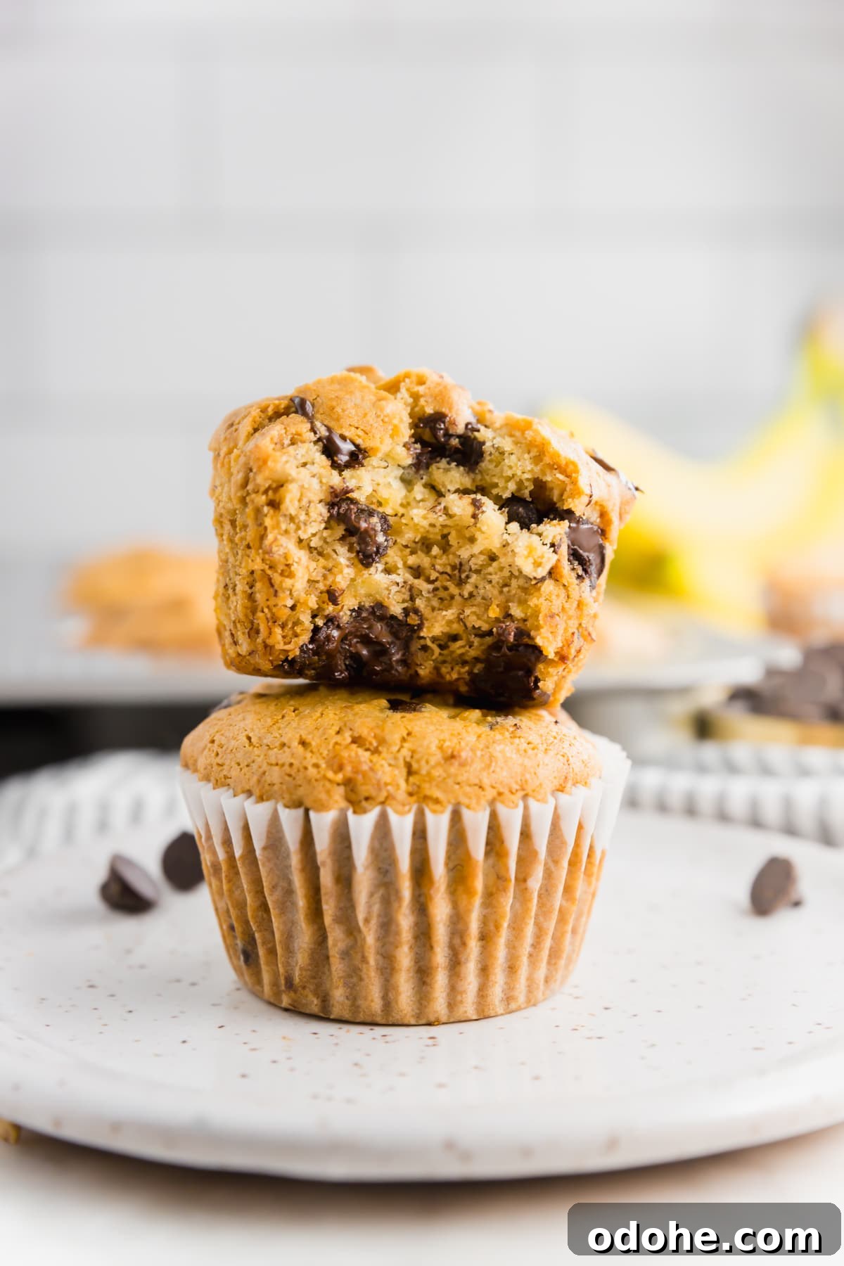 Gluten-Free Vegan Banana Chocolate Chip Muffins Recipe 128 Two gluten-free vegan banana chocolate chips banana muffins stacked on top of each other.