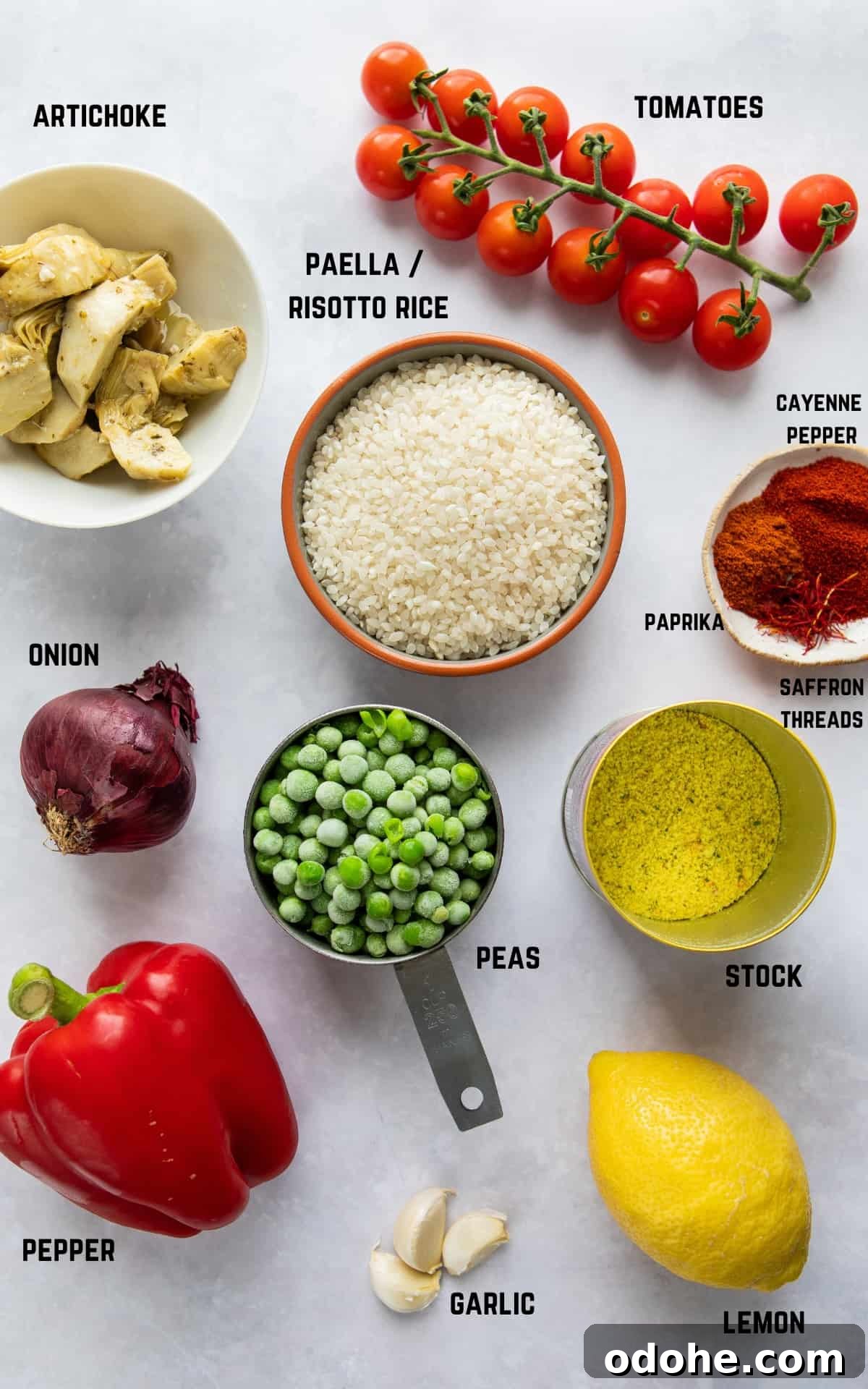 ingredients to make paella on white surface.