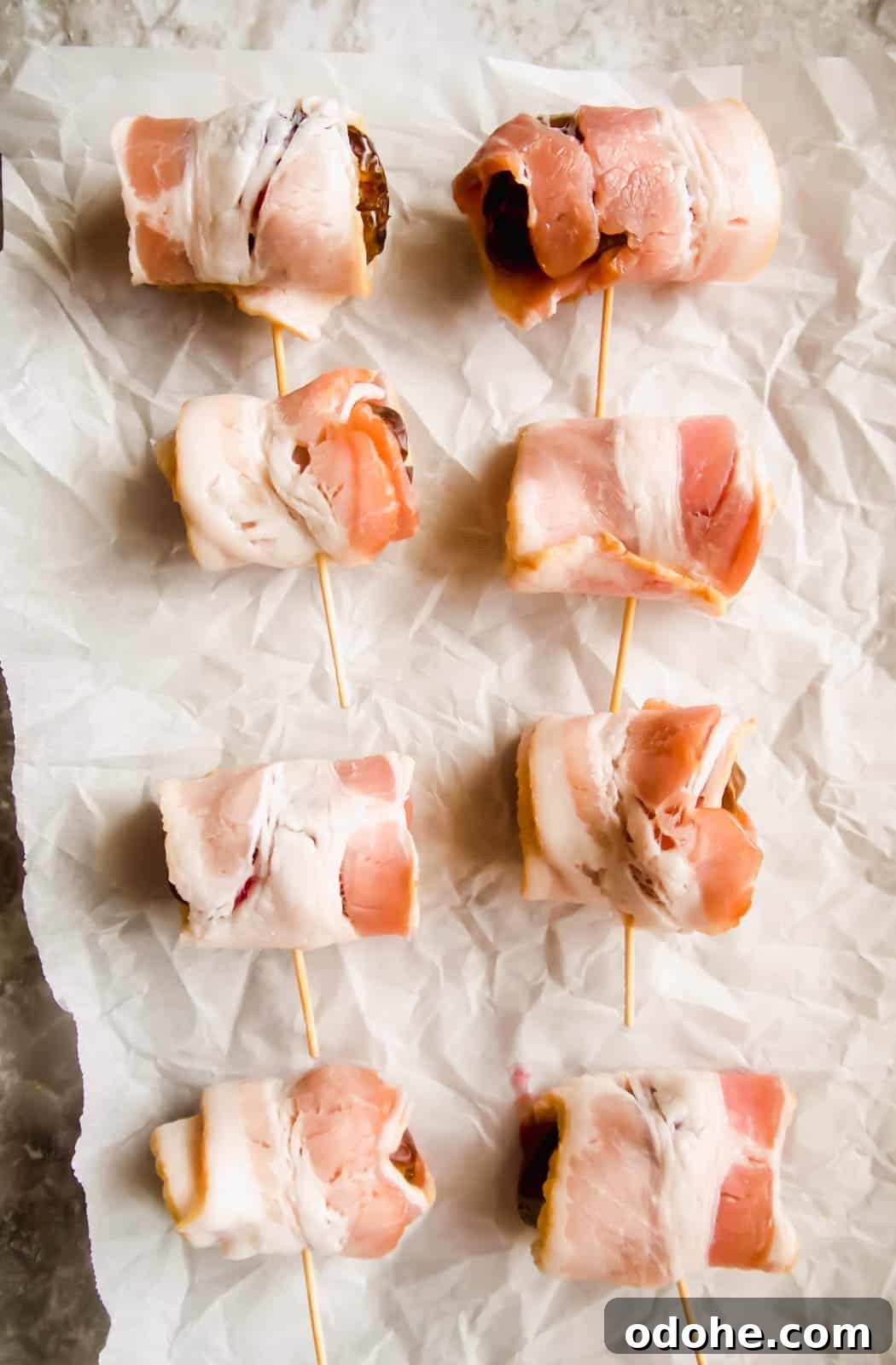 Bacon-Wrapped Raspberry-Stuffed Dates | Paleo & Whole30-Friendly 7 Raw bacon wrapping the raspberry stuffed dates before cooking.