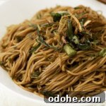 A close up of scallion oil noodles in a bowl.