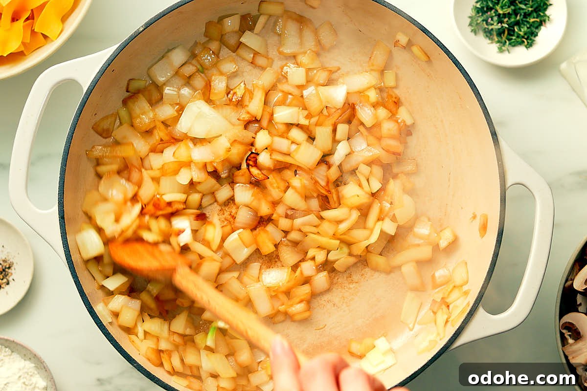 Sauteeing onions in a skillet for One Pot Mushroom Stroganoff.