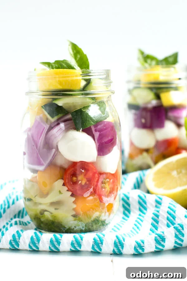 Lemon Basil Vegetable Pasta Salad in a Jar – five layers of flavors combine with a fresh lemon basil dressing to create this easy pasta salad!