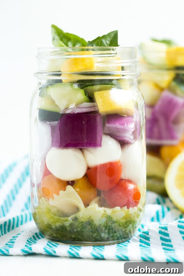 Lemon Basil Vegetable Pasta Salad in a Jar – five layers of flavors combine with a fresh lemon basil dressing to create this easy pasta salad!
