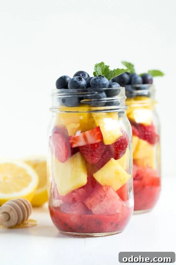 Mason Jar Fruit Salad with Strawberry Mint Dressing is made with the freshest flavors piled high in a mason jar. Kids and adults will love it!