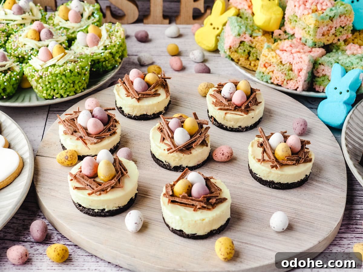 No-Bake Cheesecake Recipes: Simple, No-Oven Dessert Ideas 21 Mini egg cheesecakes on a serving board with Easter desserts and decorations in the background.