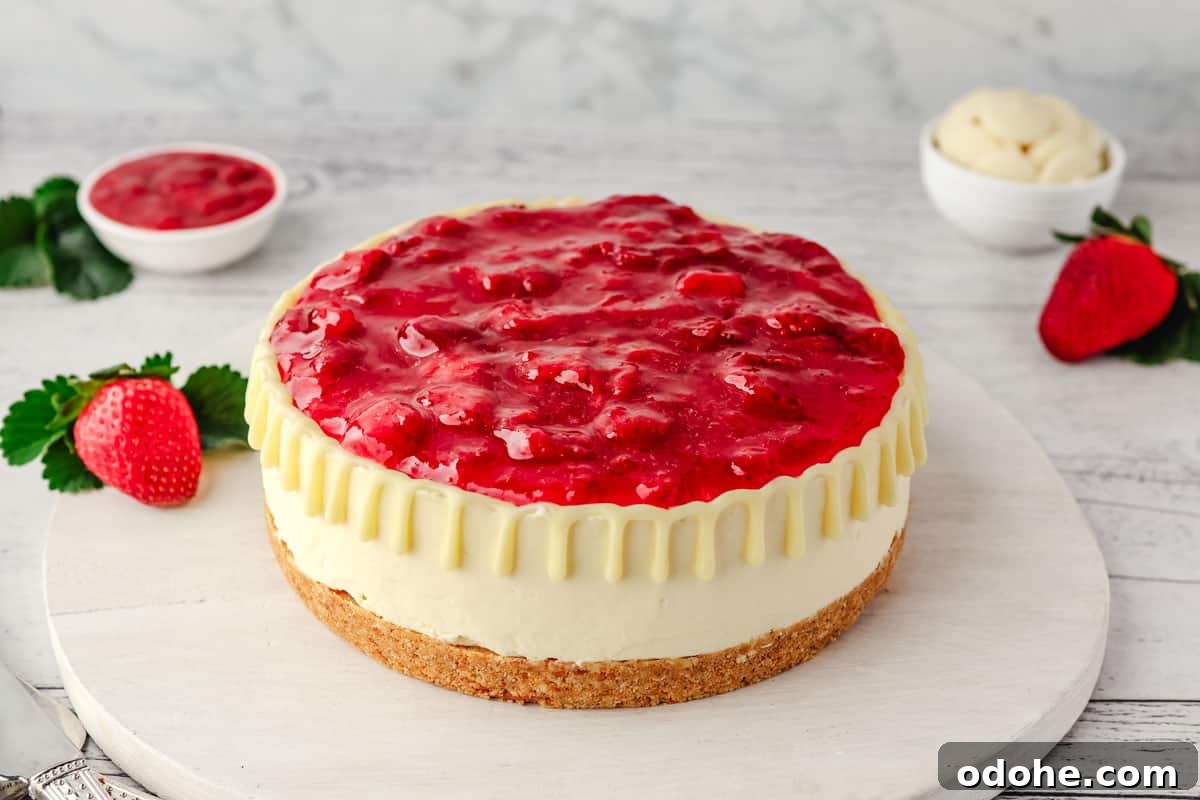 No-Bake Cheesecake Recipes: Simple, No-Oven Dessert Ideas 23 No bake White chocolate strawberry cheesecake on a serving board, with fresh strawberries, strawberry sauce and white chocolate in the background.