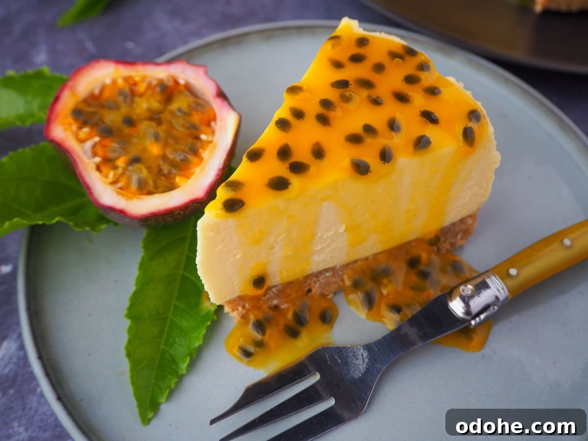 No-Bake Cheesecake Recipes: Simple, No-Oven Dessert Ideas 34 Passion fruit cheesecake with passion fruit coulis, a vintage fork in front, fresh passion fruit and passion fruit leave on the side, and rest of cheesecake in the background