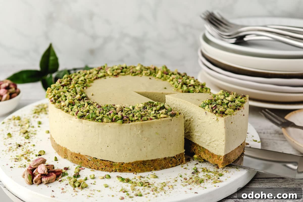 No-Bake Cheesecake Recipes: Simple, No-Oven Dessert Ideas 8 Taking a slice out of a pistachio cheesecake on a serving board.