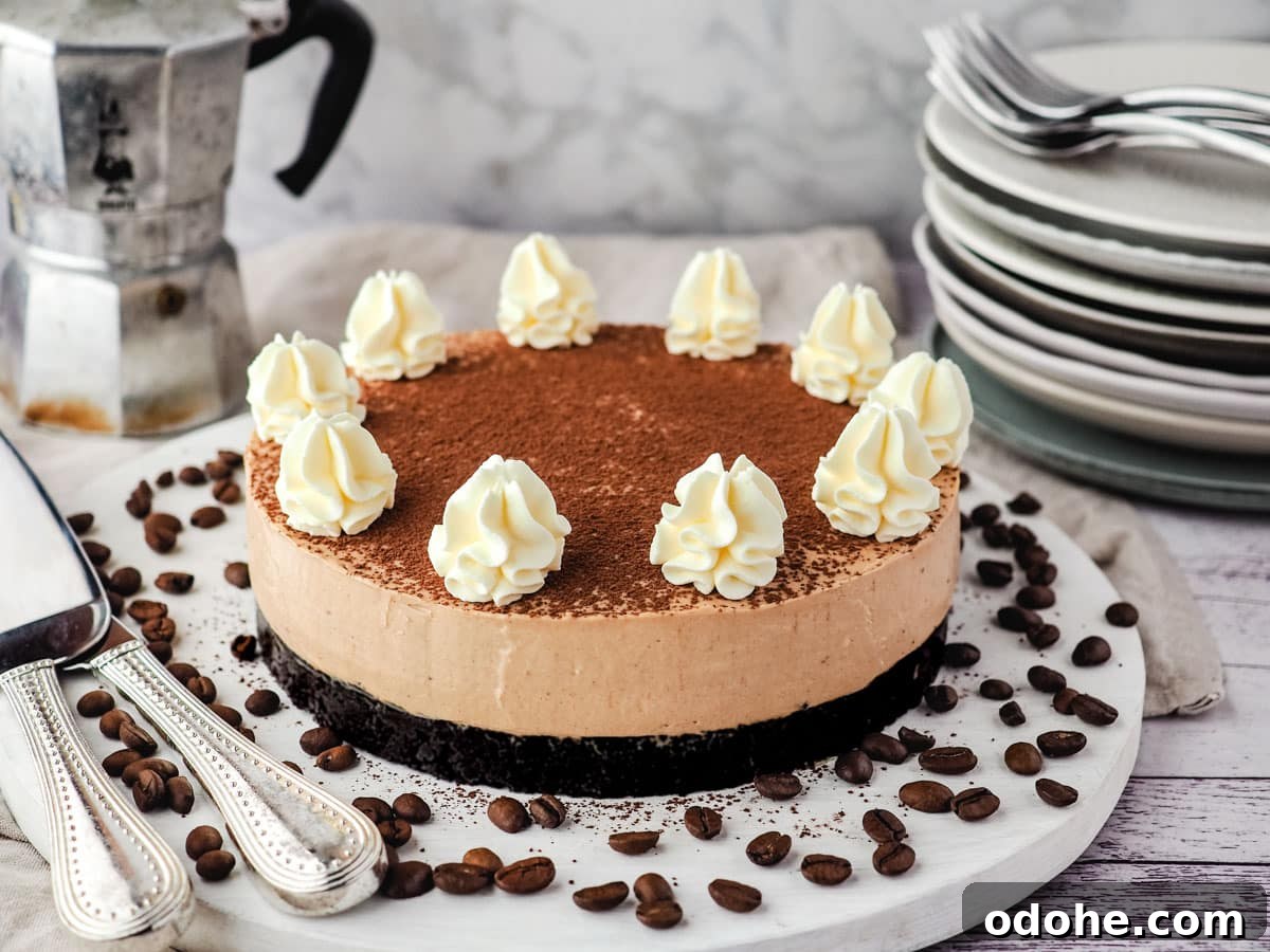 No-Bake Cheesecake Recipes: Simple, No-Oven Dessert Ideas 9 Coffee cheesecake on a serving board surrounded by coffee beans, with a stack of plates and forks and an espresso maker in the background.